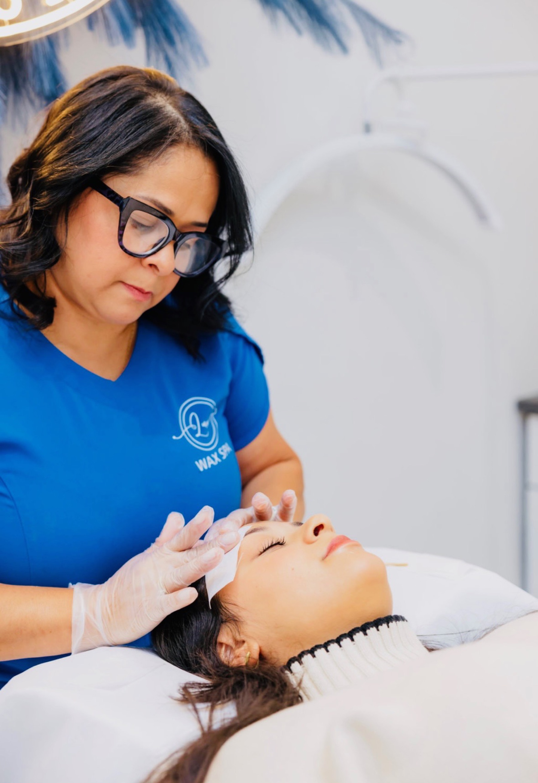Cida shaping a client's eyebrow at Luxe Wax Spa, Newtown CT